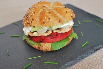 Beetroot burger with avocado, mushrooms, onion and arugula. Vegan food.