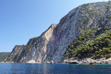 Fototapeta na wymiar paradise beach part names Chomi Beach of Liapades at Corfu Island (Greece). Sedimentary rock cliff of chalk rocks