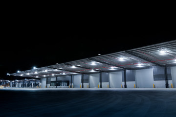 Illuminated exterior of a factory, industrial style building. Night time.