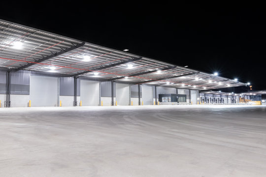 Illuminated exterior of a factory, industrial style building. Night time.