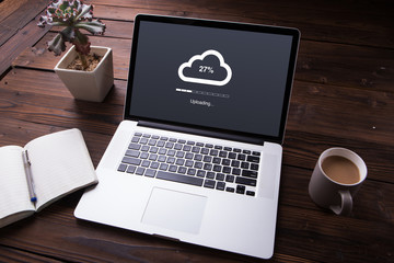 Cloud upload processing data on laptop with internet with office equipment and wooden desk background - 216658573