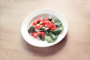appetizer of vegetables on white plate on wooden background