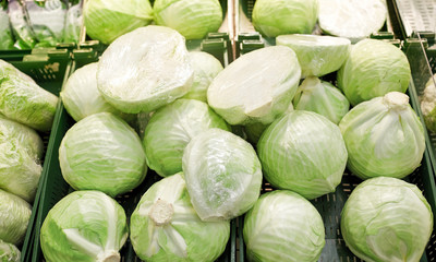 sale, harvest, food, vegetables and agriculture concept - close up of cabbage at grocery store or market