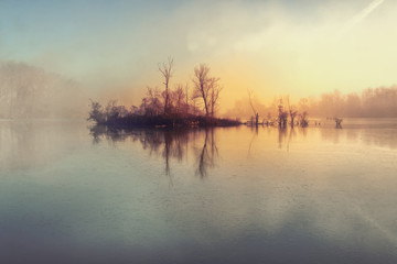 Fototapeta na wymiar Island and mysterious fog over river