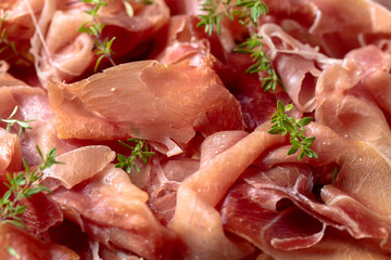 Italian prosciutto crudo or jamon with thyme .