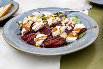 Salad with goat cheese. Goat cheese, baked pear, beetroot, roach, mangold, almond flakes, honey dumplings