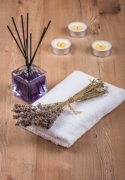 Spa decoration with candles, towels and dry lavender