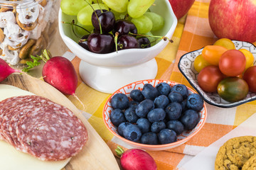 Preparation of school lunch. Cheese, salami and vegetables - ingredients for sandwiches.