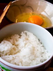 Hot and freshly cooked rice with whole raw organic egg from happy hen. Can eat as Tamago kake gohan, Japanese comfort food at its simplest as breakfast or accompany with Sukiyaki. Natural light.