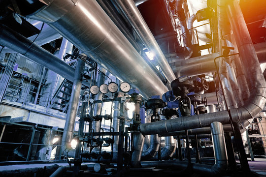 Equipment, cables and piping as found inside of a modern industrial power plant