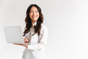 Smiling young asian businesswoman standing - Powered by Adobe