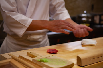 Professional sushi chef carefully using just the right pressure to make perfect sushi with confident and dedication. Precision and Finesse at its best practice to achieve top performance in business.