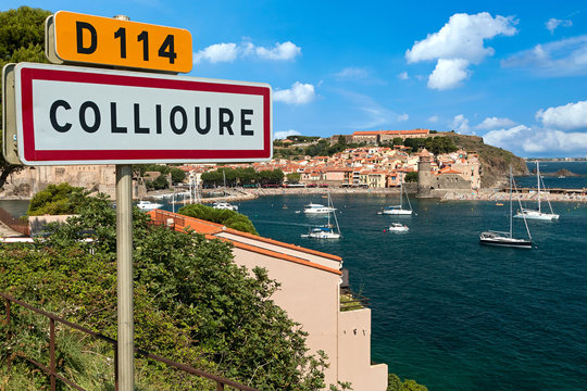 view on the bay and tower of the france french city of collioure with town sign and harbor 