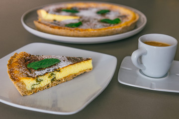 Slice of traditional Spanish cheesecake with mint Flaó (Flao) from Ibiza and cup of coffee