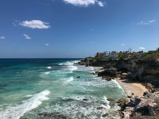 Beautiful caribbean beach with turquoise water, stone coast and windy weather, Isla Mujeres