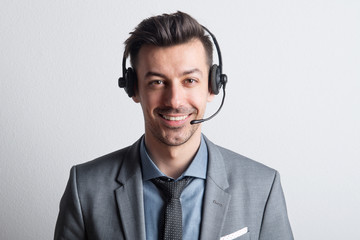 Portrait of a young man with headset in a studio. Copy space.