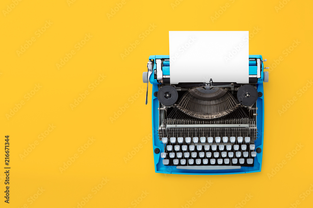 Fototapete typewriter machine in retro style on yellow background. top view.