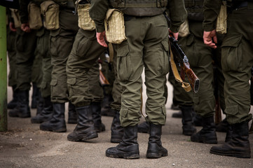 A Kalashnikov rifle in the hands of the military. War in Ukraine. Anti-terrorist operation in...
