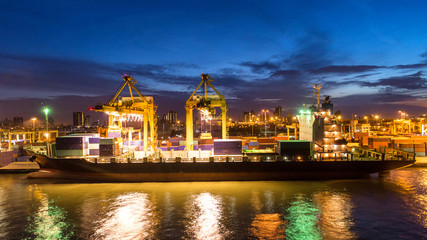 Obraz premium Container ship in export and import business and logistics. Shipping cargo to harbor by crane. Water transport International. Aerial view and top view.