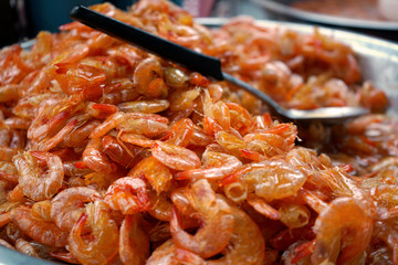 Sweet shrimp cooked on bowl with ladle at street food market.
