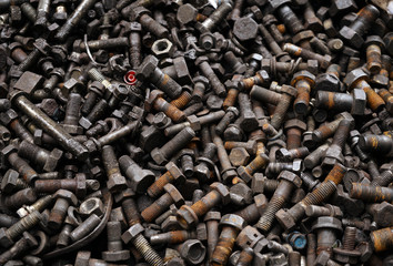 Old dirty rusty screw, bolt, metal pin and metal nuts background.