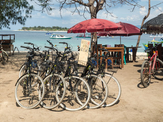 Beautiful tropical sandy beach with buildings and boats in a sea. Gili Trawangan, Indonesia. November, 2017