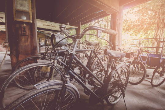 Soft focus,Vintage rusted bicycle Under house with sunset background