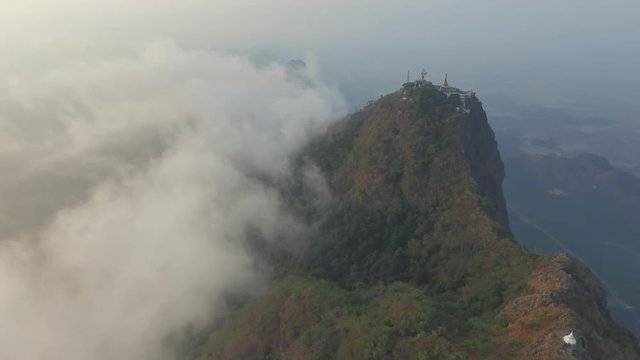 Drone shot: Mt Zwegabin during sunrise partly covered in clouds