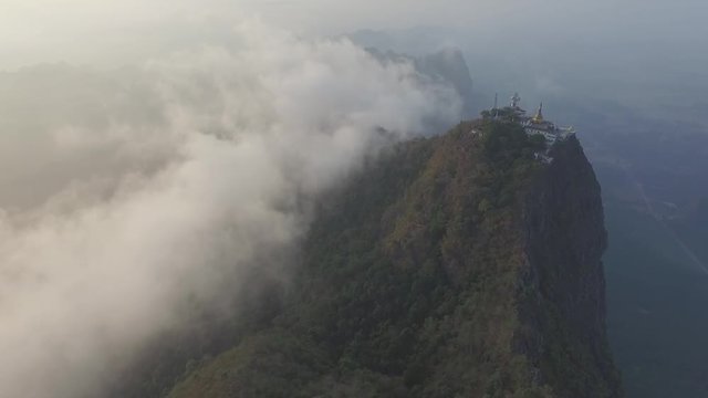 Drone shot: Mt Zwegabin during sunrise partly covered in clouds