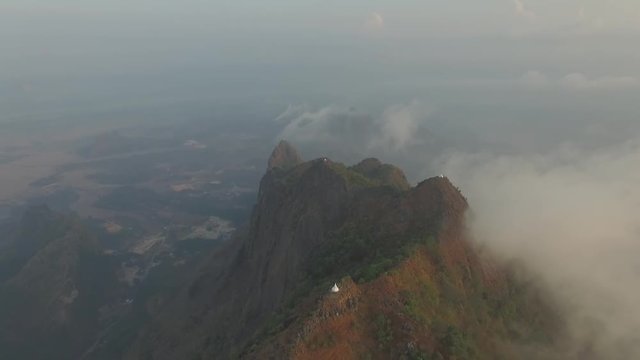 Drone shot: Mt Zwegabin during sunrise partly covered in clouds