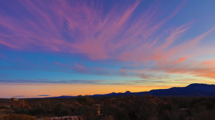 Spectacular sunrise in the Kagga Kamma Nature Reserve in South Africa with pink streaky clouds in the sky
