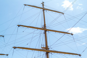 the mast with the sails against the blue sky