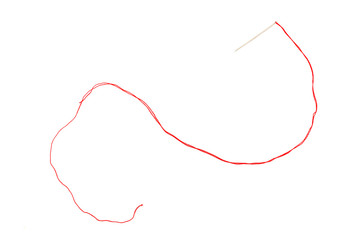 Overhead photo of a needle with a red thread on a white background