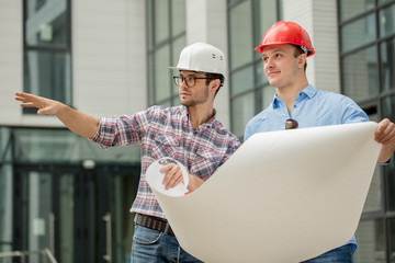 two builders are going to demolish old building. close up portrait. occupation concept