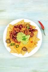 Nachos with cheese and chilli, traditional Mexican snack, with copyspace