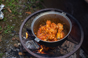 Cooking Harcho or Kharcho traditional Georgian soup food in Mingrelia with beef or chicken decorated with fresh chopped coriander leaves. Making kharcho in kettle on open fire. Georgia Samegrelo food