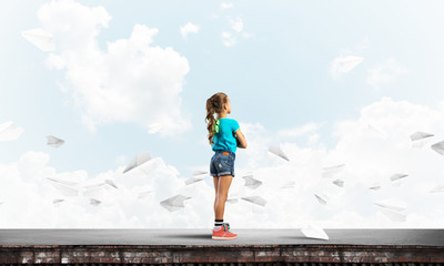 Concept of careless happy childhood with girl looking far away