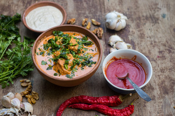 Harcho or Kharcho traditional Georgian soup food in Mingrelia with beef or chicken, rice, cherry plum purée and chopped walnut and decorated with fresh chopped coriander leaves. Georgia Samegrelo food