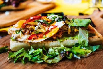 Sandwich with chicken, cheese and golden French fries potatoes