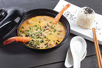 Tom yam soup with seafood on dark background
