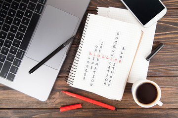 Paper notebook With blogging word, laptop computer.social media concept