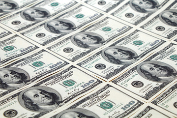 American dollars are spread out on the table.