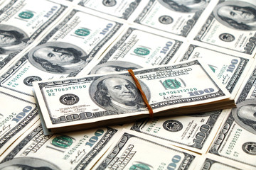 American dollars are spread out on the table.