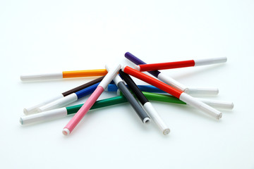 Multi-colored bright felt-tip pens on a white background