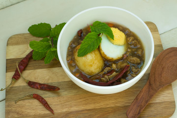 Egg with Tamarind Sauce on white wood