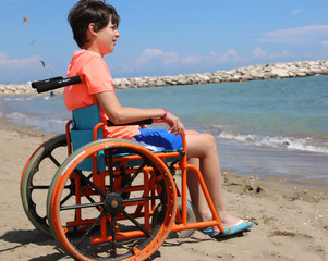 boy on the special wheelchair with large wheels to move smoothly