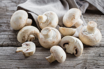 Fresh mushrooms champignons on a wooden background. Autumn Harvest Food Vegetarian Vegetable