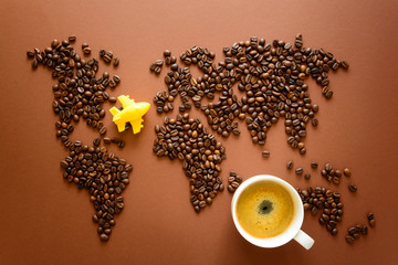 Map of the world made of roasted arabica coffee beans on brown paper background. International...