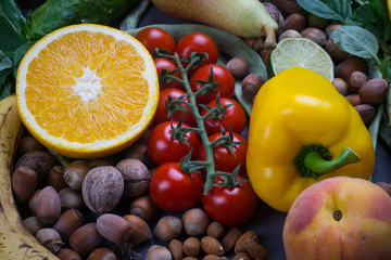 Healthy food background, frame of organic food. Ingredients for healthy cooking: vegetables, fruits, nuts, spices. Balanced diet food on a dark black background. Close-up.