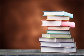 Graduation hat and stacks of books